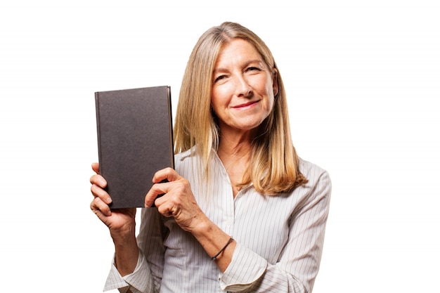 Mujer mayor sujetando un libro negro