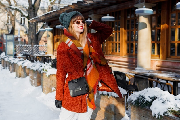 Mujer de moda en traje de invierno con estilo caminando por la ciudad