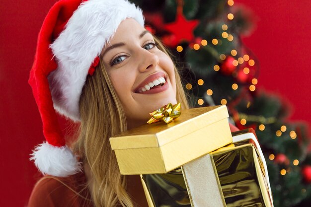 Mujer con una montaña de regalos de colores en sus manos