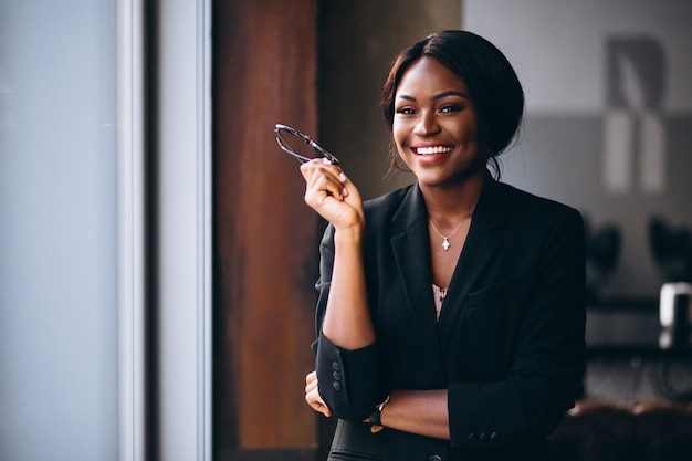 Mujer de negocios afroamericana por la ventana