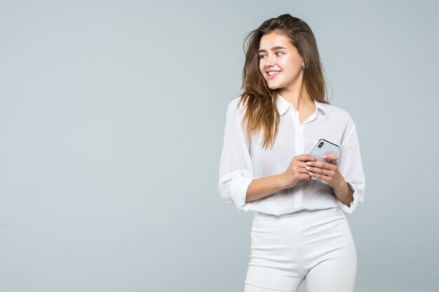 Mujer de negocios enviando mensajes de texto en su teléfono móvil - aislado sobre fondo blanco