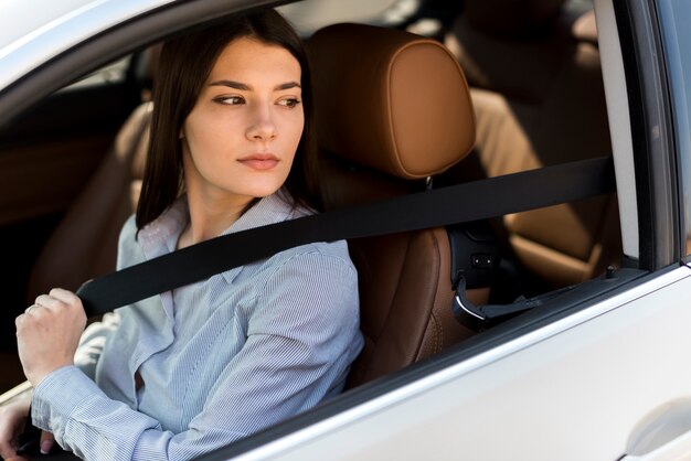 Mujer de negocios morena dentro de un coche