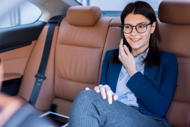 Foto gratuita mujer de negocios morena dentro de un coche