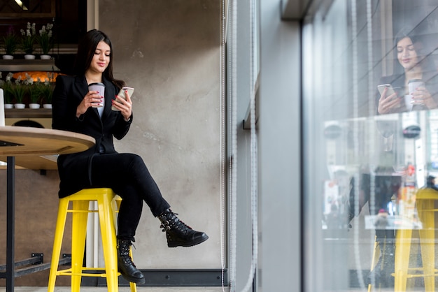 Mujer de negocios morena usando su smartphone