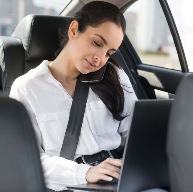 Mujer de negocios trabajando desde el auto