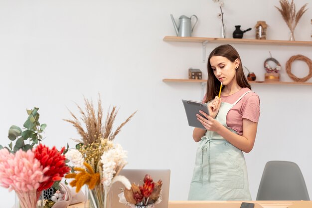 Mujer de negocios usando una tableta digital en su propia tienda
