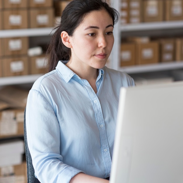 Foto gratuita mujer de negocios de vista lateral trabajando en equipo portátil