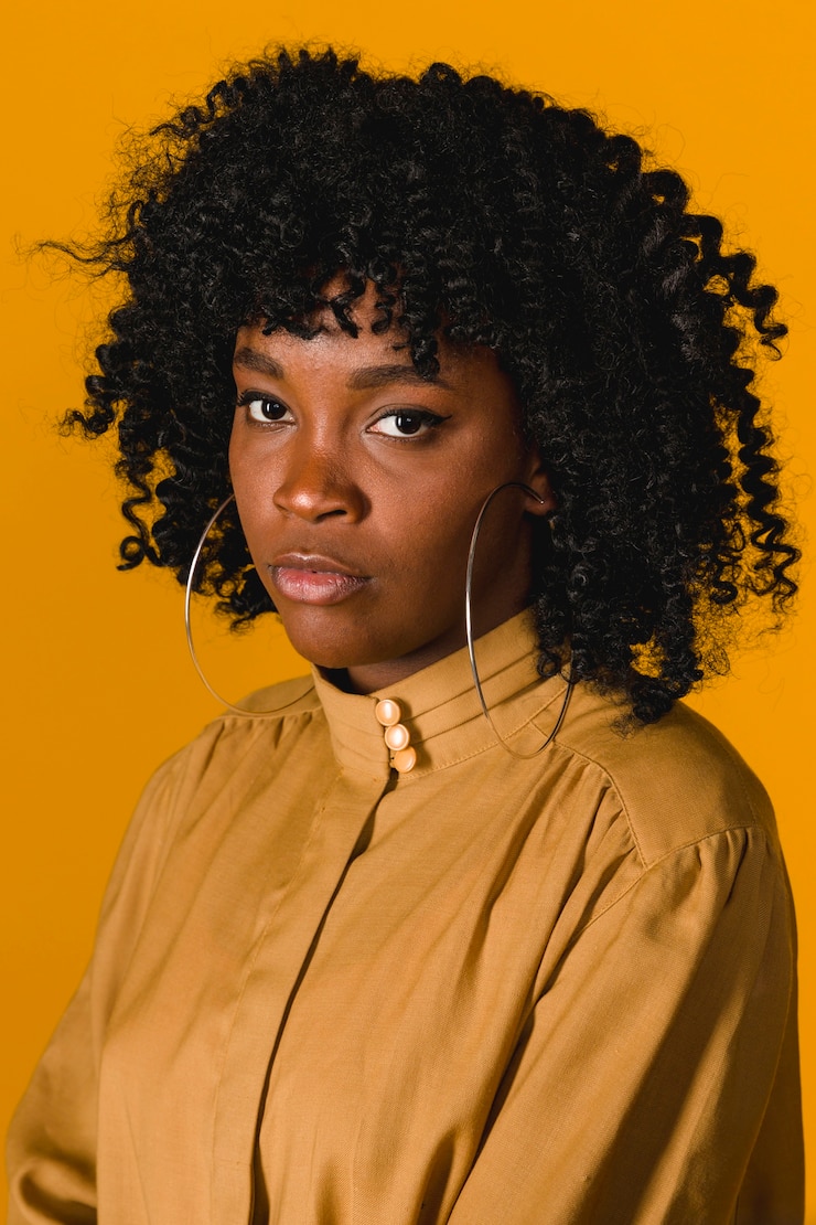 Foto gratuito mujer negra joven seria que mira la cámara