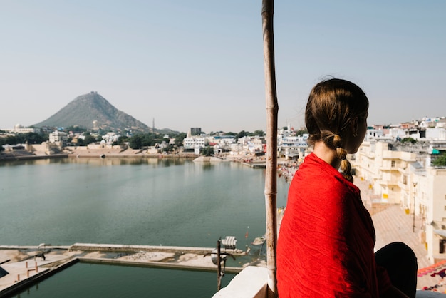 Mujer occidental disfrutando de una vista del lago Pushkar en Rajasthan