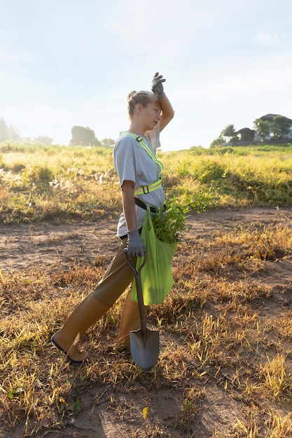 Mujer con pala en el campo