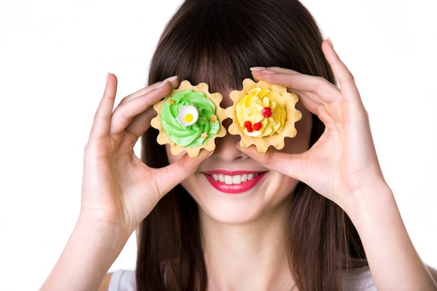 Mujer con pasteles de colores en los ojos