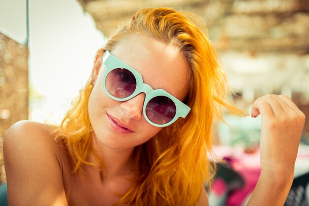 Mujer pelirroja en el café de la playa