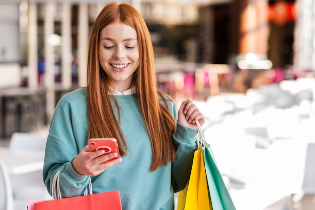 Mujer pelirroja revisando su teléfono