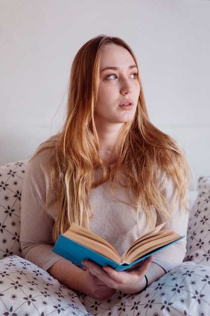 Foto gratuita mujer pensativa con libro