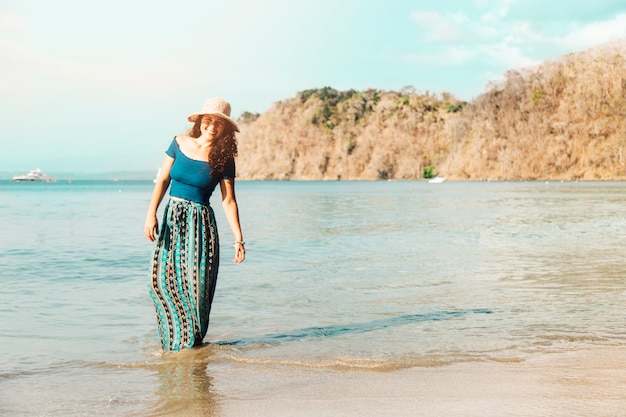 Mujer de pie en el agua a la orilla del mar