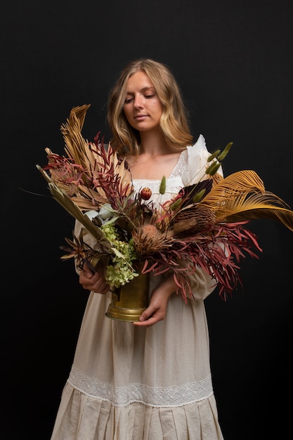 Mujer con plantas secas plano medio