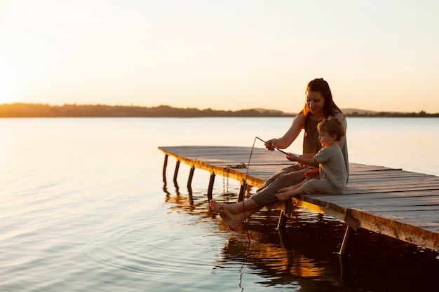 Mujer en la playa con su bebé disfrutando del atardecer