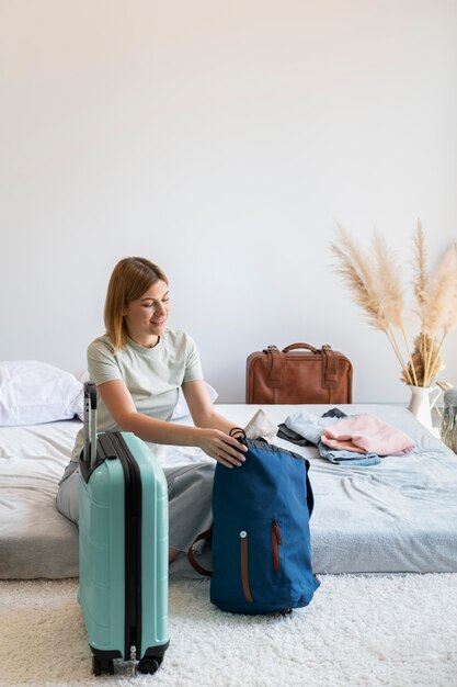 Mujer poniendo ropa en una maleta para las próximas vacaciones