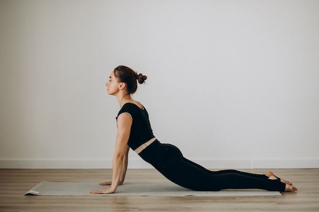 Mujer practica pilates en el gimnasio de yoga