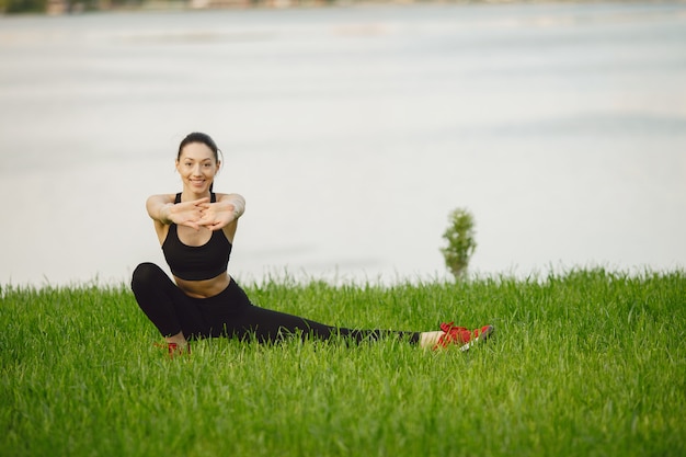 Mujer practicando yoga avanzado por el agua