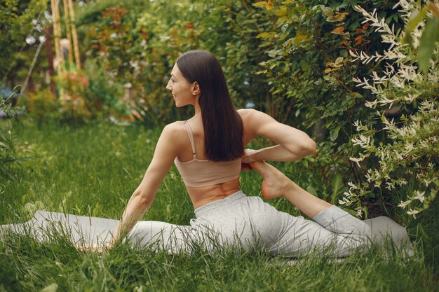 Mujer practicando yoga avanzado en un parque