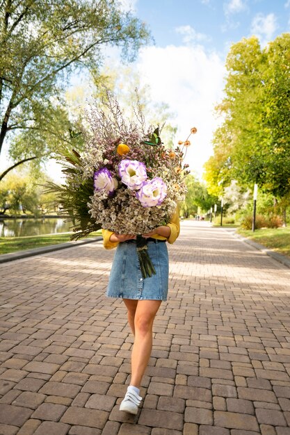 mujer, en, el, primavera, tenencia, ramo de flores