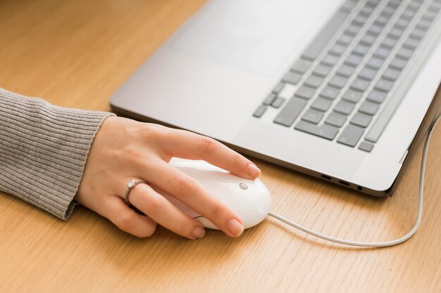 Mujer de primer plano en la computadora portátil con mouse