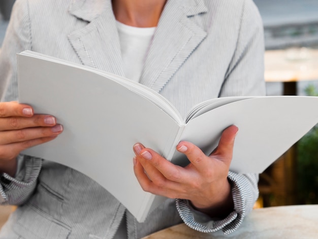 Mujer de primer plano leyendo una revista de maquetas