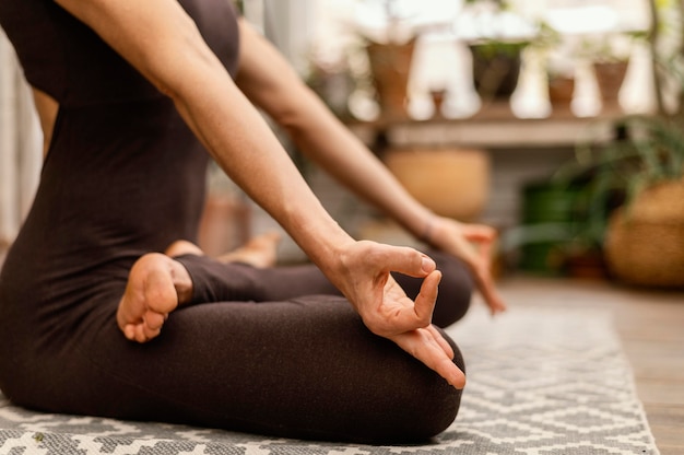 Mujer de primer plano meditando en el interior