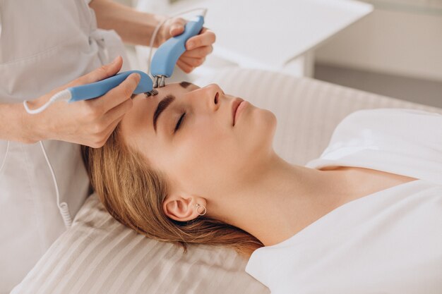 Mujer con procedimientos de tratamiento de belleza en un salón