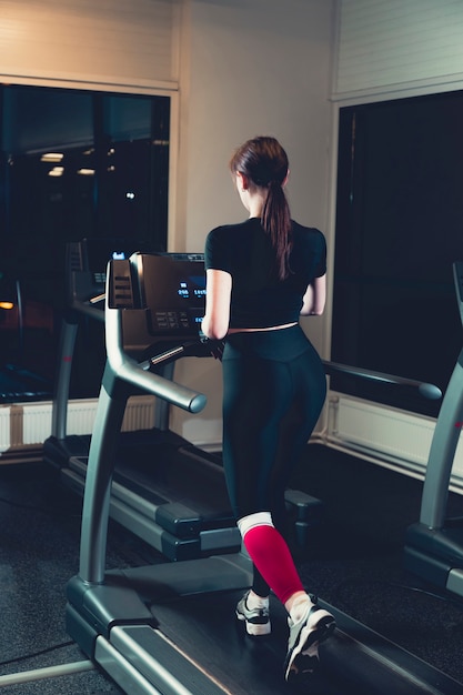 Foto gratuita mujer que ejercita en la rueda de ardilla en gimnasio