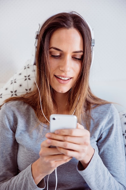 Foto gratuita mujer que elige música en smartphone