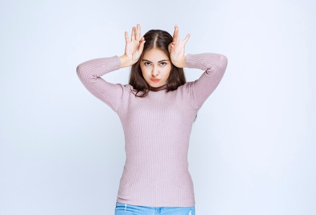 mujer que se lleva las manos a la cabeza y parece confundida.