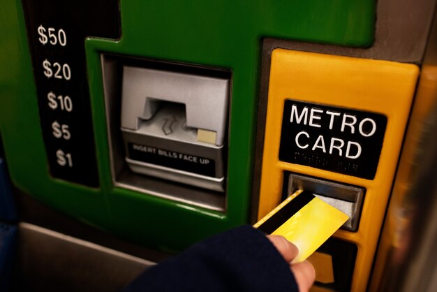 Mujer que usa una tarjeta de metro para viajar con el metro en la ciudad