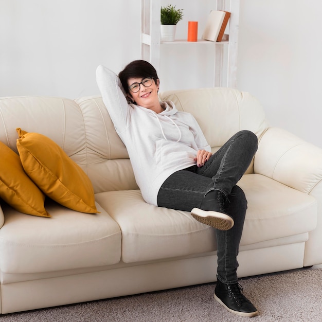 Mujer relajante en casa en el sofá