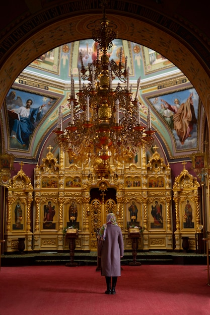 Mujer rezando en la iglesia para la peregrinación religiosa