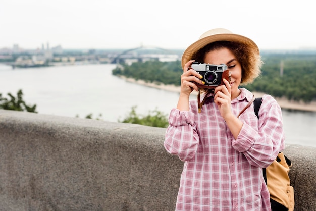 Foto gratuita mujer rizada tomando una foto con espacio de copia