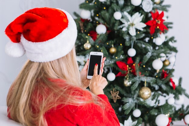 Mujer, en, santa sombrero, con, teléfono