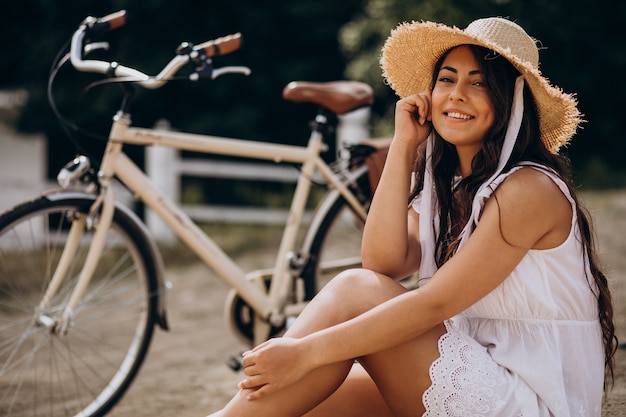 Foto gratuita mujer sentada en la playa en bicicleta