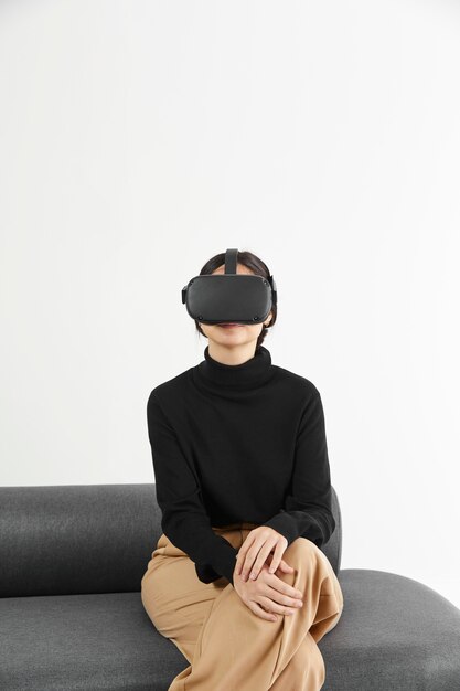 Mujer en el sofá con casco de realidad virtual