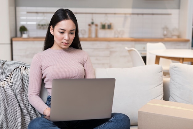 Mujer en el sofá con laptop en el regazo