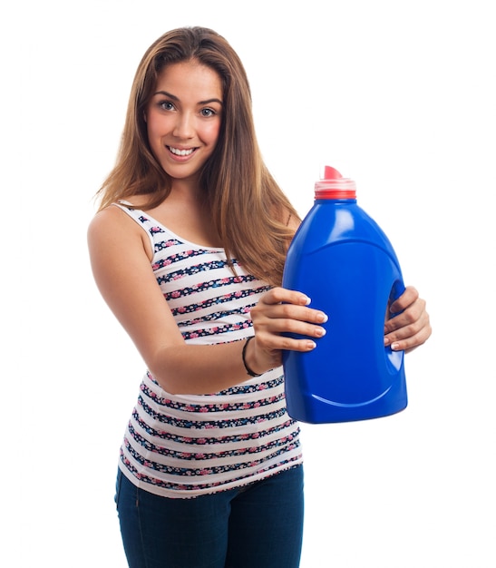 Mujer sonriendo con un bote de detergente azul