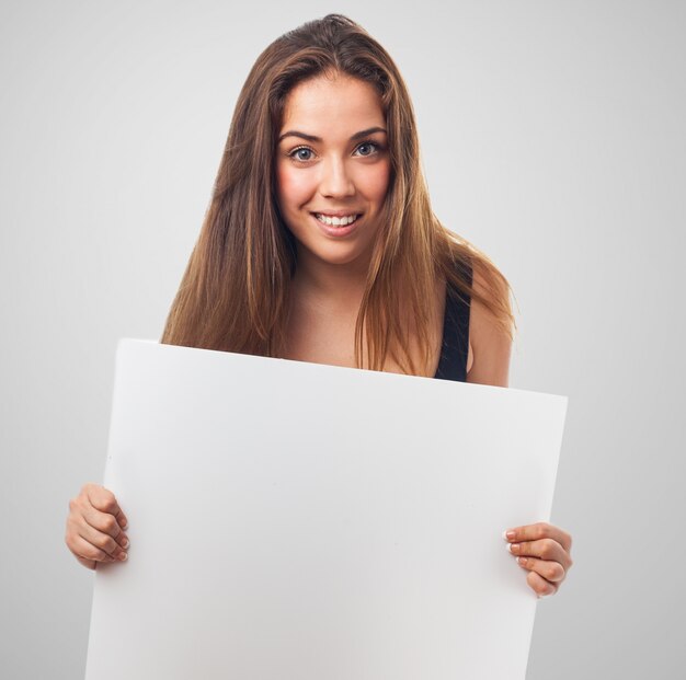 Mujer sonriendo con un cartel