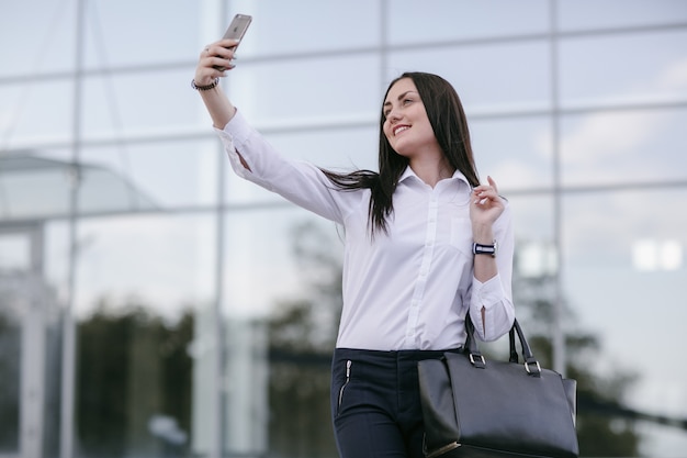 Mujer sonriendo mientras se hace una foto a sí misma