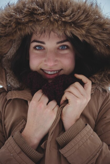 Mujer sonriente en chaqueta de piel durante el invierno