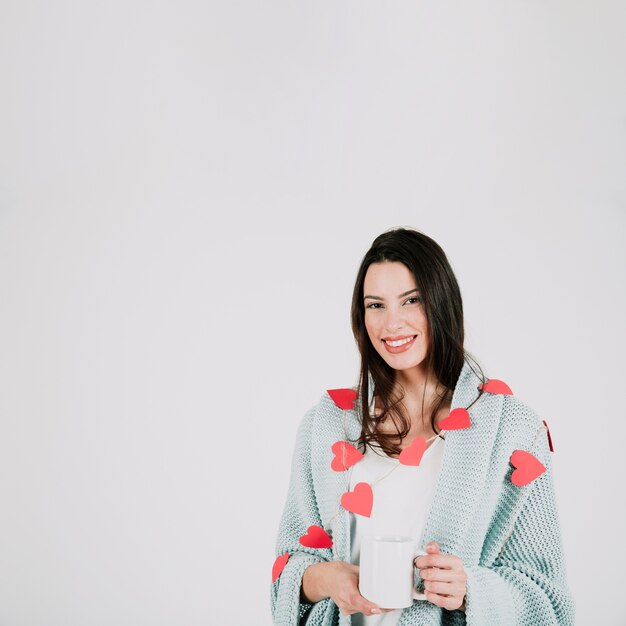 Mujer sonriente con cuadros y taza