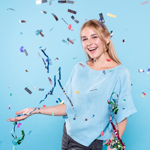 Mujer sonriente disfrutando de tiempo de confeti