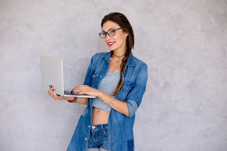Foto gratuito mujer sonriente escribiendo en la computadora portátil