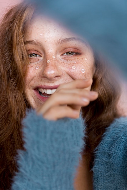 Foto gratuita mujer sonriente con flores blancas en el rostro