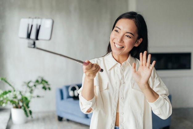 Foto gratuita mujer sonriente haciendo un vlog en casa